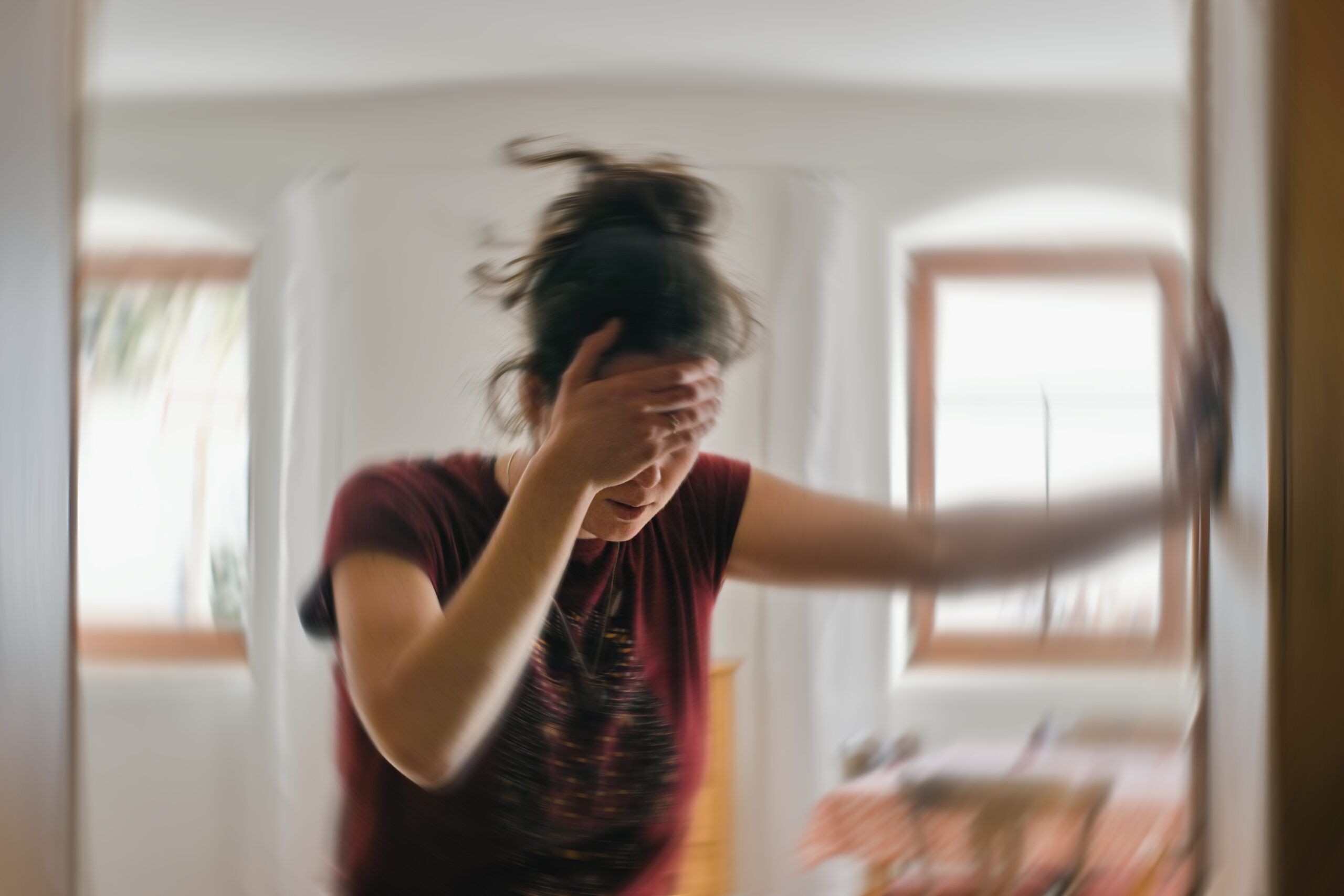 Blured,Photo,Of,A,Woman,Suffering,From,Vertigo,Or,Dizziness